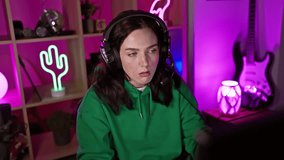 Pensive woman with headphones in neon-lit gaming room looking at screen - Powered by Shutterstock - Get 15% off with code: PIKWIZARD15