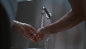 Surgeon doctor washes his hands before surgery in a special modern room with a stainless medical sink in the clinic preparing for surgery - Powered by Shutterstock - Get 15% off with code: PIKWIZARD15