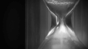 Time flows backwards, in opposite direction. Sand in hourglass. Time cures all things. Time is great healer. 4K Slow Motion time reversed video in retro style, old filming - Powered by Shutterstock - Get 15% off with code: PIKWIZARD15