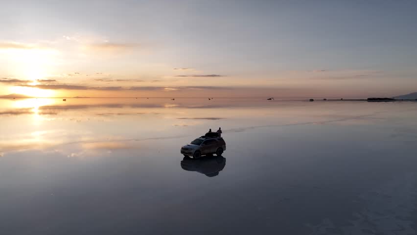 Salar de Uyuni in Bolivia during sunset. Aerial image taken with a drone. Uyuni Salt Flats. Altiplano, Bolivia. Rainy Season. Tunupa Volcano. Clouds Reflection on Water in Lake Surface