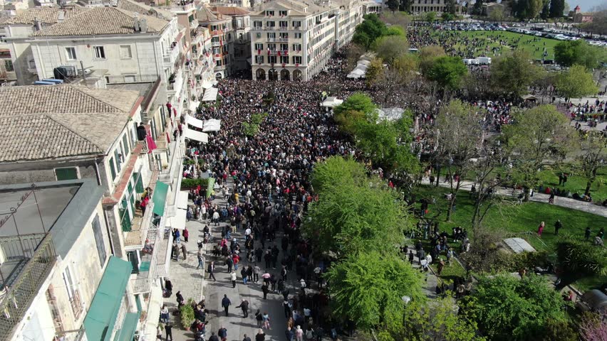 At 11:00am on Holy Saturday, as is customary, Corfians throw jugs from balconies at the Liston Spaniada promenade on Holy Saturday, to celebrate the Resurrection. Royalty-Free Stock Footage #3478789471