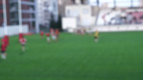 Rugby training session on stadium field, defocused view.