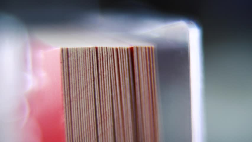 Macro shot of a pile of visit cards in stock, red card, super slow motion, Full HD, tilt down smooth movement