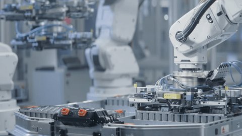 Close-up of Lithium-Ion EV Battery Pack for Automotive Industry Assembly Process. Automated Production Line with White Robotic Arms at Bright Factory. Electric Car Manufacturing Line with Robot Arms 스톡 비디오