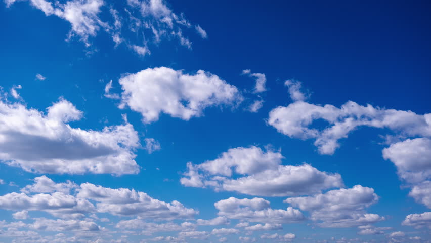 Timelapse of cumulus clouds moves in the blue sky. The background of light and heavy calm clouds changes shape in cloudy space. Natural background, time-lapse, copy space. 4K.