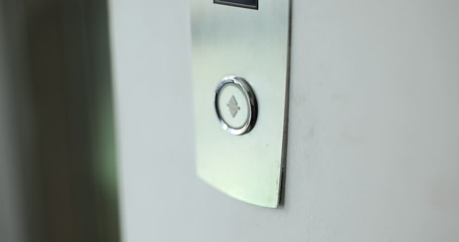 Woman presses the elevator button. Elevator door control concept