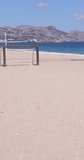Portrait footage of the beautiful beach in Albir, Altea, Alicante in Spain showing soccer football nets on the beach front by the ocean on the beach known as Playa de Cap Blanch