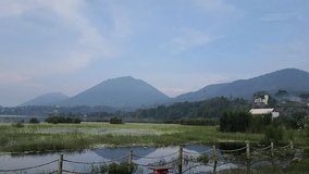 Raw footage of beratan lake with mountain and hill view located in bedugul, tabanan, bali, Indonesia