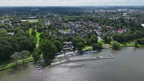 An aerial drone view of residential buildings along Aasee Lake in Münster-Aaseestadt, Germany.