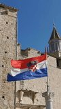 Croatian flag on a flagpole in the city of Trogir, Croatia. Vertical Video