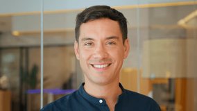 Happy young latin business man leader or worker looking at camera standing in office. Smiling businessman manager, smiling professional employee or male entrepreneur, close up portrait. - Powered by Shutterstock - Get 15% off with code: PIKWIZARD15