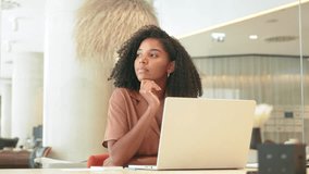 Busy young African American business woman employee using laptop working in modern office. Professional businesswoman executive, company worker or manager looking at computer technology at work. - Powered by Shutterstock - Get 15% off with code: PIKWIZARD15