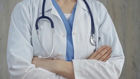 Confident healthcare professional with stethoscope. Close-up of a medical doctor in white coat with folded arms. Medicine concept