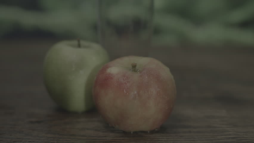 Zooming in on wet red apple with trees and nature background Royalty-Free Stock Footage #3479265637