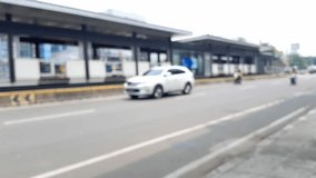 Blurred video of traffic in front of the Transjakarta bus rapid transit line.