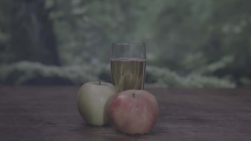 Zooming in on wet red apple with trees and nature background Royalty-Free Stock Footage #3479300209