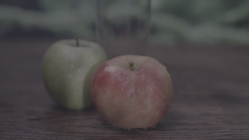 Zooming in on wet red apple with trees and nature background Royalty-Free Stock Footage #3479300247