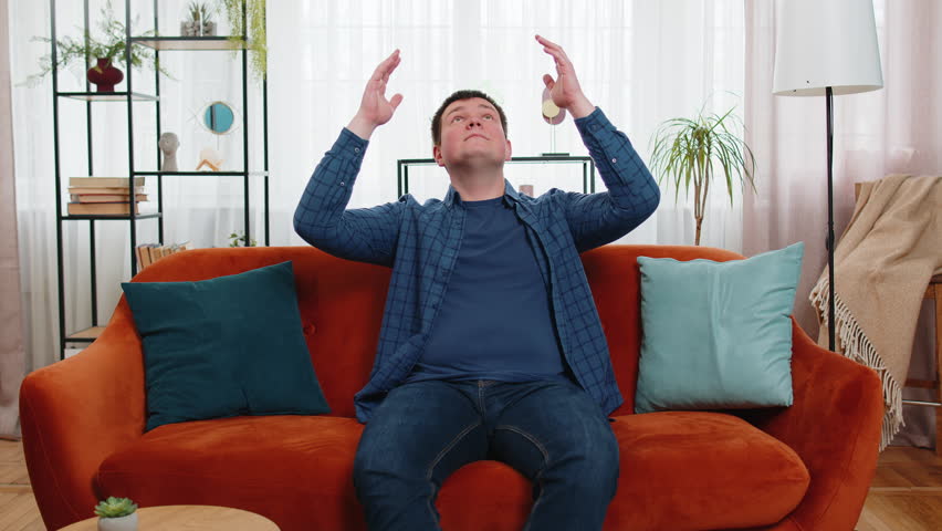 Repair work at neighbors. Irritated Caucasian man covers ears with cushions pillows annoyed by noisy loud music suffer from headache wishes silence. Thin walls at home flat without sound insulation. Royalty-Free Stock Footage #3479371725