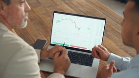 Financial advisor explaining invest stock market data consulting investor working in office. Stock market traders working on financial chart analysis using laptop. Hands pointing on screen close up. - Powered by Shutterstock - Get 15% off with code: PIKWIZARD15