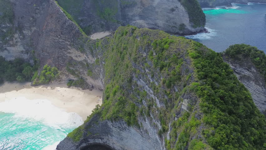 Drone aerial footage over a cliff in Bali. Indonesia beautiful sea landcape. Adventure travel agency.