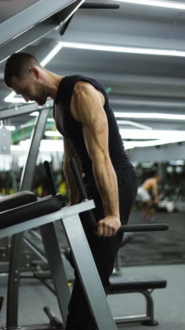 Athlete man training force push up and pull up exercise on bars in gym