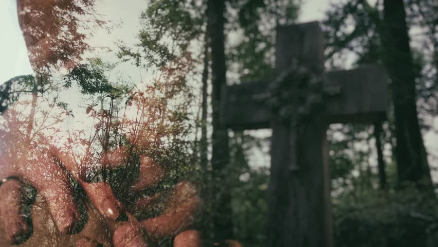 Woman weeping by cross grave marker in grief and sadness 