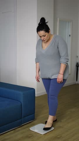 Young woman fat feel upset after measuring scale at home