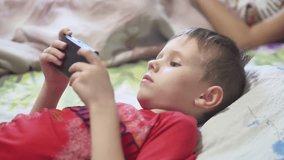 portable console games console boy lying in bed