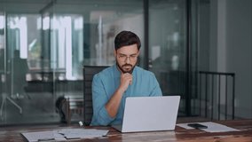 Busy Latin financial expert checking documents working at laptop in office. Serious business man accountant eading law paper company file invoice overview looking at computer at workplace. - Powered by Shutterstock - Get 15% off with code: PIKWIZARD15