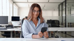 Smiling mature business woman executive using mobile phone working in office. Happy middle aged businesswoman holding smartphone, professional female executive looking at cellphone at workplace. - Powered by Shutterstock - Get 15% off with code: PIKWIZARD15