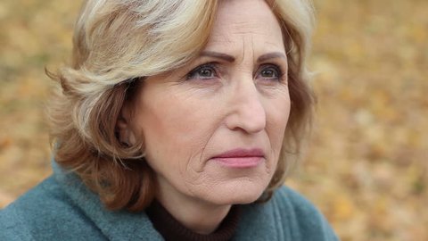 Senior woman, widow talking with God about injustice of lost close lovely person