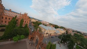 Aerial view of Chernivtsi university, flying above a unesco world heritage site in Ukraine, famous historical building, Ukraine, Magnificent old university building with towers, domes and green garden