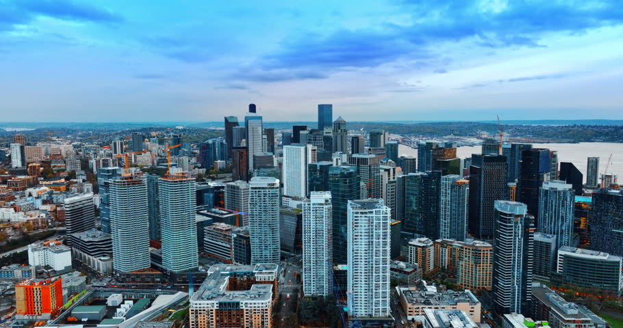 A group of high modern skyscrapers looking alike in the downtown of modern metropolis. Twilight view of Seattle, Washington, the USA. Aerial view.