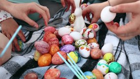 coloring Easter eggs with colorful paints. Religion and traditions. Easter celebration. Process of making handmade painted Easter eggs
