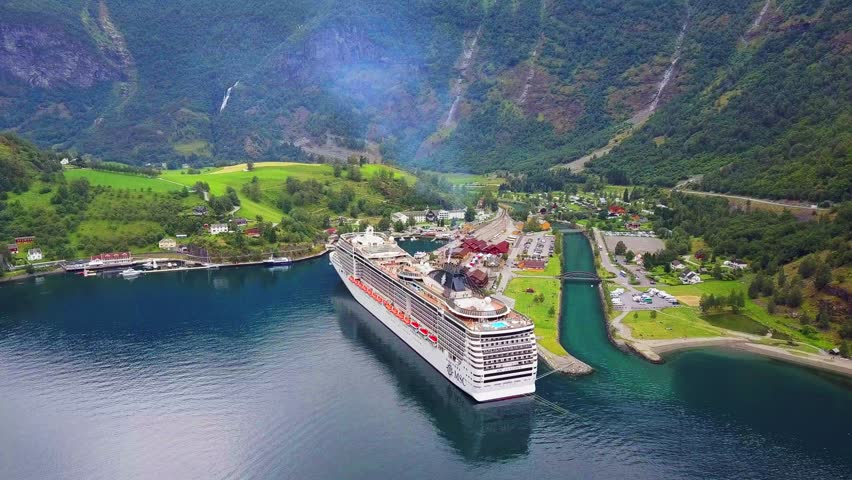 Cruise ship in Flam aerial view. Flam is a village in Flamsdalen, at the Aurlandsfjord a branch of Sognefjord, municipality of Aurland, Norway. Royalty-Free Stock Footage #3479993615