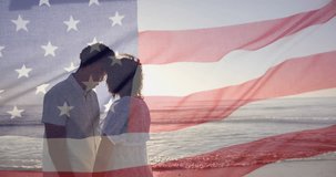 Animation of american flag over diverse couple embracing on sunny beach. America, summer, vacations, romance, love, celebration and patriotism, digitally generated video.