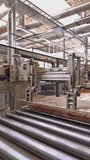 Modern equipment cleans the wooden boards to an ideal state for subsequent sales. Woodworking factory. Close-up. Vertical video