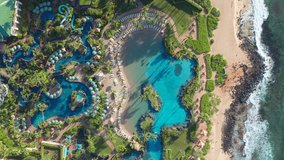 Luxury 5 star Hotel Resort top down drone view. Palm trees, sunshade, parasol, hot tub and water slide in beautiful pattern. Pools, garden, shoreline and beach from overhead aerial 4k view - Powered by Shutterstock - Get 15% off with code: PIKWIZARD15