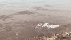 4k video of river wave moving onto the sandy beach
