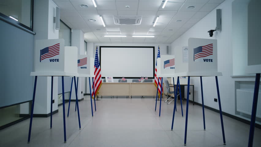 National Election Day in the United States of America. Dolly shot of voting booths with American flag logo in polling station office. Political races of US presidential candidates. Democracy concept.