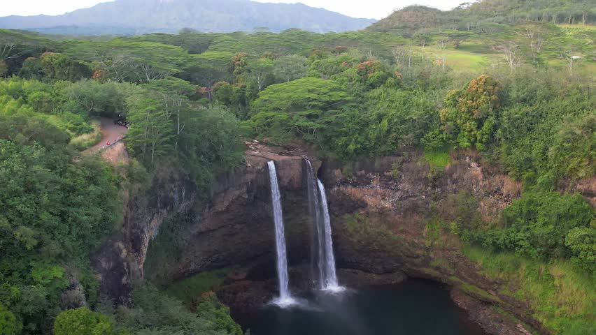 Kauai - 3.19.2024 - very good aerial footage moving out over the wailua falls of kauai, hawaii.