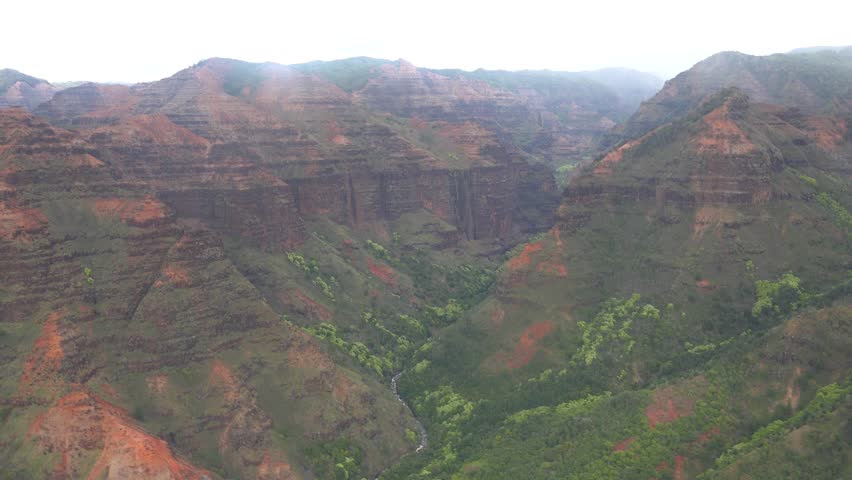 Kauai - 3.19.2024 - great aerial footage moving across the waimea canyon on a foggy day in kauai, hawaii.