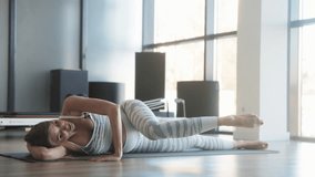 Prenatal Yoga Practitioner Relaxing with Side-Lying Leg Stretch Exercise - Powered by Shutterstock - Get 15% off with code: PIKWIZARD15
