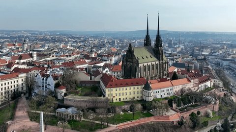 Brno, Czechia. Roman Catholic cathedral. Originally medieval in gothic style, many renovations, High towers added in Gothic revival between 1901-1909. Aerial view. Spilberk castle in the background: film stockowy