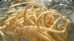 Cooked Spaghetti Swirling in Boiling Water, with Air Bubbles Rising Upward Through the Strands of Pasta - an Underwater View - Powered by Shutterstock - Get 15% off with code: PIKWIZARD15
