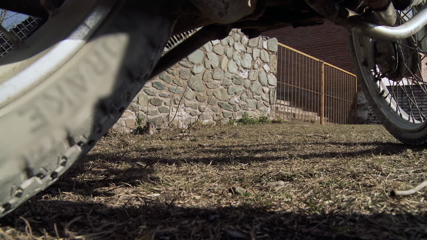Motorcyclist Using Kickstand while Getting Off the Motorcycle. Low Angle View. 4K Resolution.