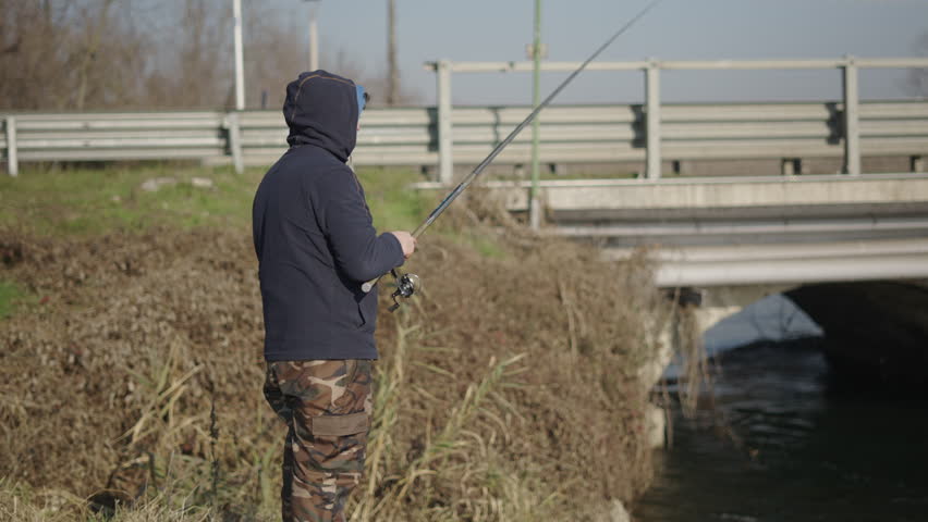 A fisherman trying to catch something
