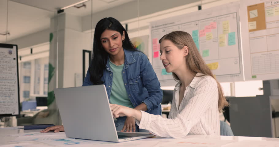 Two women colleagues engaged in teamwork in office, using laptop, make sales analysis, review report, charts and graphs, brainstorming solutions, making decisions based on data, prepare presentations Royalty-Free Stock Footage #3480567571