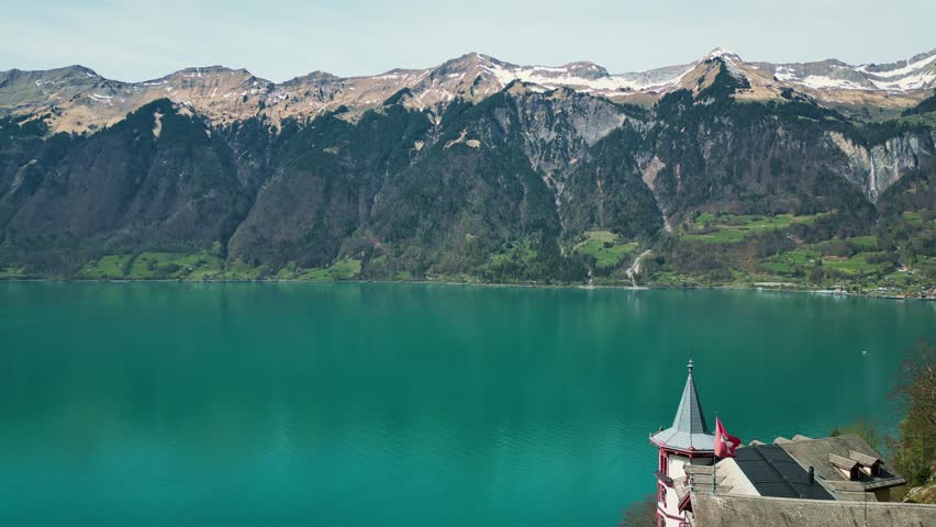Picturesque Brienz lake with turquoise water and snowy rocky mountain range on horizon. Majestic mountain landscape in Switzerland Alps
