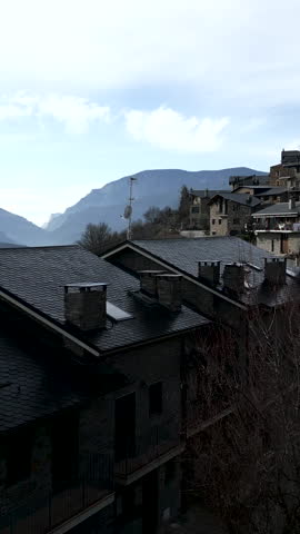 The drone crosses the roofs of some mountain houses